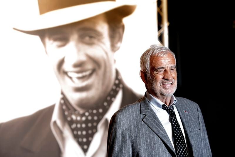 In this Oct. 14, 2013 file photo, French actor Jean-Paul Belmondo poses for photographers as he arrives at the opening ceremony of the 5th edition of the Lumiere Festival, in Lyon, France. (AP Photo/Laurent Cipriani, File)