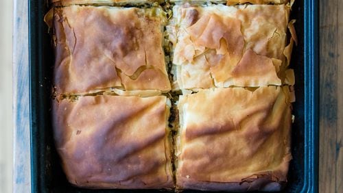 A pan full of spanakopita, the Greek phyllo pie made with a Southern twist: collard greens and kale have been substituted for the spinach. CONTRIBUTED BY HENRI HOLLIS
