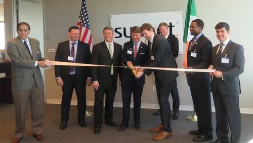 The ribbon has been cut on Sysnet's Brookhaven location, which will eventually create 500 jobs for DeKalb County. Shown are Brookhaven Chamber of Commerce President Alan Goodman, Sysnet Chief People Officer Patrick Condren, Brookhaven Mayor John Ernst, Commissioner Pat Wilson of the Ga Dept of Economic Development, Sysnet CEO Gabriel Moynagh, Consul General of Ireland Shane Stephens, Decide DeKalb Development Authority President Ray Gilley and Sysnet U.S. GM John Browne.