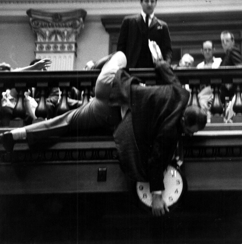 In 1964, state Rep. Denmark Groover, D-Macon, dangled dangerously from the House balcony in an effort to keep the chamber's clock from reaching midnight. AJC file.