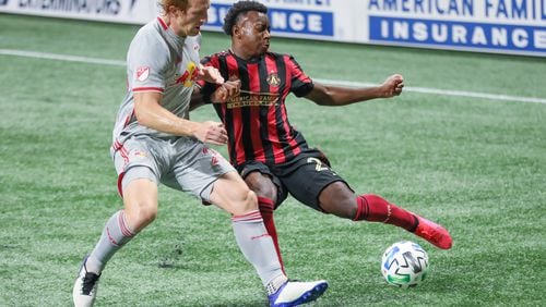 Atlanta United defender George Bello (21) prepares to pass while being defended by New York Red Bulls defender Tim Parker (26) during the second half Saturday, Oct. 10, 2020, at Mercedes-Benz Stadium in Atlanta. (Branden Camp/For the AJC)