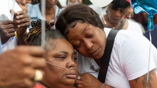 Arnitra Hollman, right, embraces Santeesh Crews, left, during a vigil and balloon release for Johnny Hollman on Tuesday, August 15, 2023, at Mary Shy Scott Park in Atlanta. Hollman died after he became unresponsive during an encounter with Atlanta police. (Michael Blackshire/Michael.blackshire@ajc.com)
