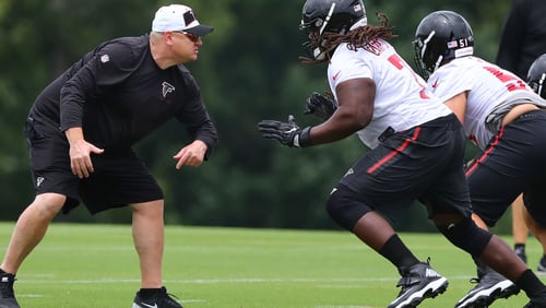 Down in the trenches: Offensive line coach Chris Morgan gets in some work with guard James Carpenter during Wednesday's minicamp practice in Flowery Branch. (Curtis Compton/ccompton@ajc.com).