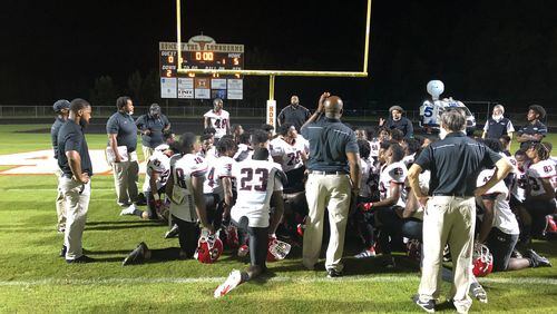 The Dutchtown football team huddles up after its 5-0 loss to Lanier.