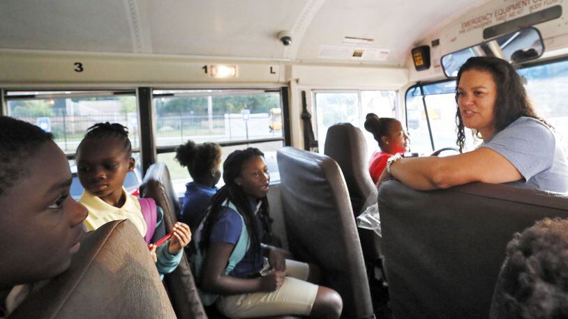 Atlanta Public Schools Superintendent Meria Carstarphen greets children on a school bus on Aug. 12, 2019, the first day of the school year. BOB ANDRES / ROBERT.ANDRES@AJC.COM