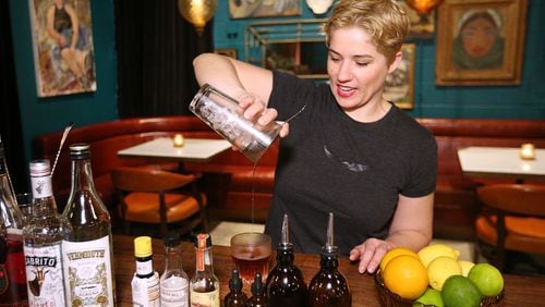 Kathryn DiMenichi, co-owner of Cardinal and Third Street Goods, mixes up a Common Tiger cocktail, a new addition to the fall drink menu. Curtis Compton/ccompton@ajc.com