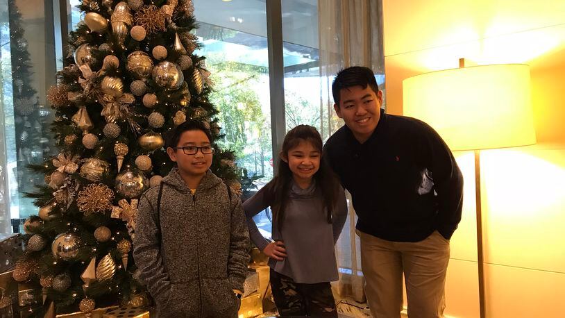 Angelica Hale poses with two fans Marvin (rightr) and Martin (left) in the J.W. Marriott lobby by Lenox November 20, 2017. CREDIT: Rodney Ho/rho@ajc.com
