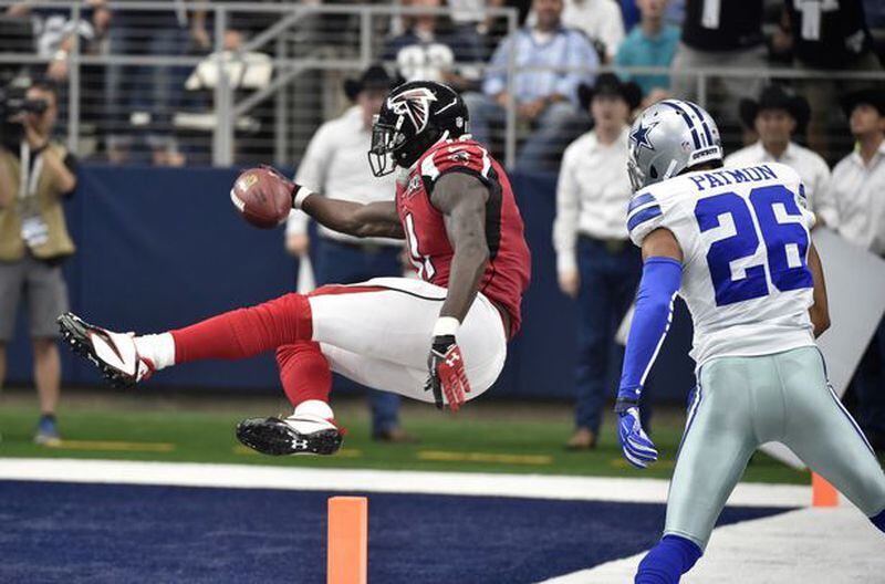 Atlanta Falcons wide receiver Julio Jones (11) sails into the end zone for a touchdown as Dallas Cowboys defensive back Tyler Patmon (26) watches in the second half of an NFL football game in Arlington, Texas. (AP Photo/Michael Ainsworth)