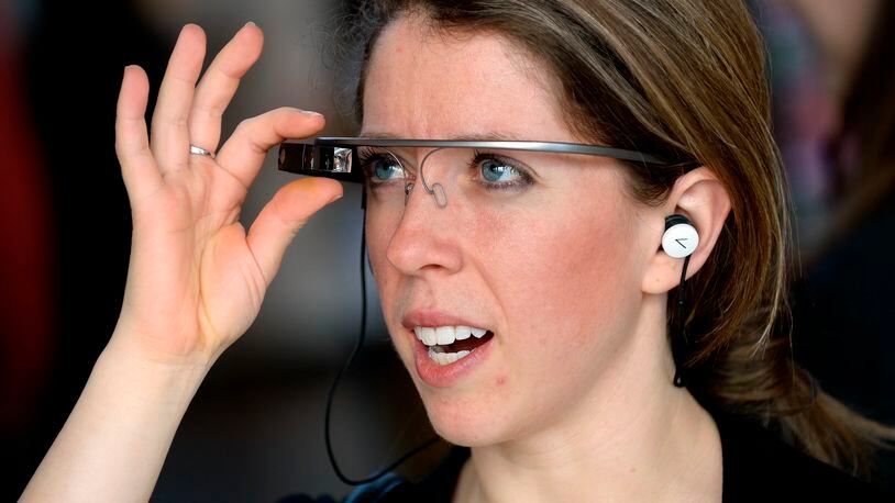 Sarah Cook uses voice commands to communicate with a Google Glass wearable computer headset during a demonstration at Puritan Mill in 2014, in Atlanta. Similar technology could radically revamp retail. David Tulis / AJC Special