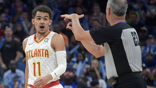 Hawks guard Trae Young (11) receives a technical foul from official Jason Phillips (23) while arguing after a score by the Orlando Magic on Friday. (AP Photo/Phelan M. Ebenhack)