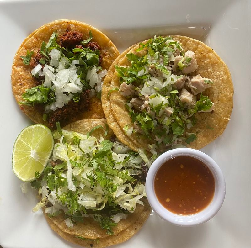 Birrieria Landeros offers four filings for its $2.99 street tacos. Clockwise, from top left: chorizo, lechon (pork) and asado (steak). Not pictured are the birria (lamb) tacos. Ligaya Figueras/ligaya.figueras@ajc.com