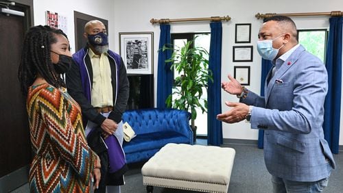 Morris Brown's president Dr. Kevin E. James (right) talks to incoming student Nala Miller (left) as her father and Morris Brown alumnus Jeffery Miller looks at Morris Brown College on Wednesday, April 21, 2021. (Hyosub Shin / Hyosub.Shin@ajc.com)