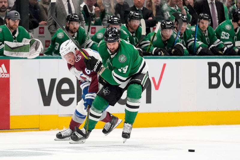 Colorado Avalanche left wing Artturi Lehkonen (62) and Dallas Stars left wing Jamie Benn (14) chase after control of the puck in the second period in Game 2 of an NHL hockey Stanley Cup second-round playoff series in Dallas, Tuesday, May 7, 2024. (AP Photo/LM Otero)