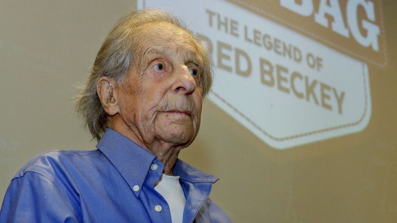 In this photo taken July 26, 2016 in Seattle, Fred Beckey, the legendary mountain climber who has bagged more first ascents than any other mountaineer and wrote the definitive guidebooks to a major North American mountain range, sits in front of a screen bearing the logo for “Dirtbag: The Legend of Fred Beckey,” an upcoming documentary feature film about his life. Beckey, 93, was waiting to begin narrating a personal slide show to a sold-out crowd at an event to kick-off a funding drive for the movie. (AP Photo/Ted S. Warren)