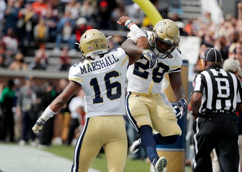 Georgia Tech's quarterback TaQuon Marshall (left) celebrates with teammate J.J. Green after Marshall ran the ball for a touchdown in the first quarter against Virginia Tech.