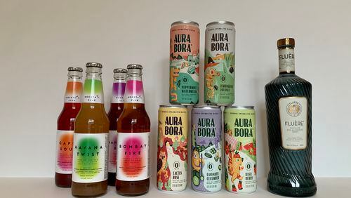 Mocktail Club's bottled drinks, Aura Bora cans of sparkling water and Fluére's distilled spirit are three nonalcoholic options to add to your home bar. Angela Hansberger for The Atlanta Journal-Constitution