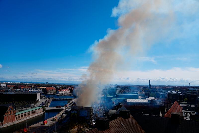 Smoke rises out of the Old Stock Exchange, Boersen, in Copenhagen, Denmark, Tuesday, April 16, 2024. One of Copenhagen’s oldest buildings is on fire and its iconic spire has collapsed. The copper roof of the 17th-century Old Stock Exchange, or Boersen, that was once Denmark’s financial center, was engulfed in flames Tuesday. (Ida Marie Odgaard/Ritzau Scanpix via AP)
