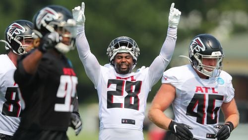 Falcons running back Mike Davis signals touchdown after the offense scores against the defense on the third day of training camp practice Saturday, July 31, 2021, in Flowery Branch. (Curtis Compton / Curtis.Compton@ajc.com)