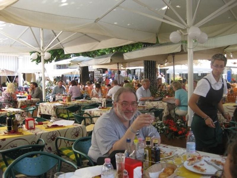 Writer Bill King is seen lunching al fresco at Ristorante Pizzeria in Stresa, a tourist town on Lake Maggiore in northern Italy. (Courtesy of Leslie King)