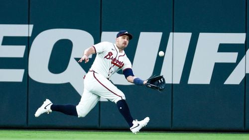 Atlanta Braves outfielder Adam Duvall (14) makes a catch during the seventh inning at Truist Park on Tuesday, May 7, 2024.
(Miguel Martinez/ AJC)