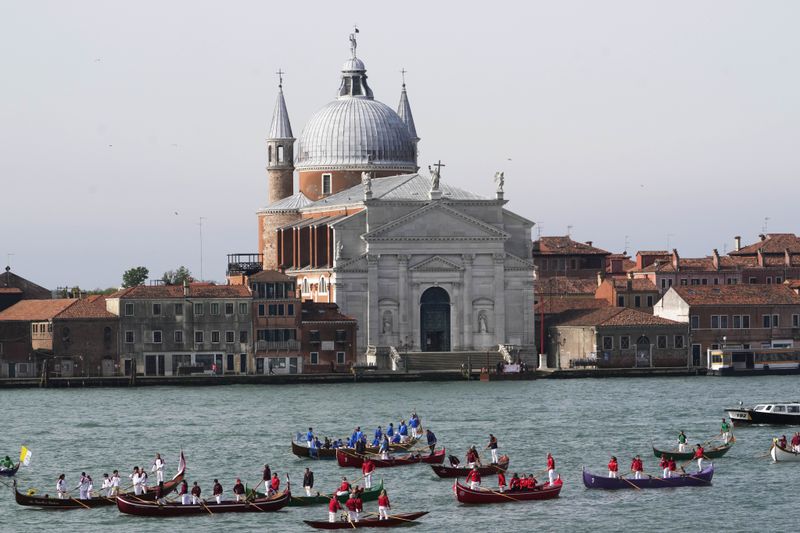 Gondoliers wait for arrival of Pope Francis in front of the Santissimo Redentore church in Venice, Sunday, April 28, 2024. The Pontiff arrived for his first-ever visit to the lagoon town including the Vatican pavilion at the 60th Biennal of Arts. (AP Photo/Alessandra Tarantino)