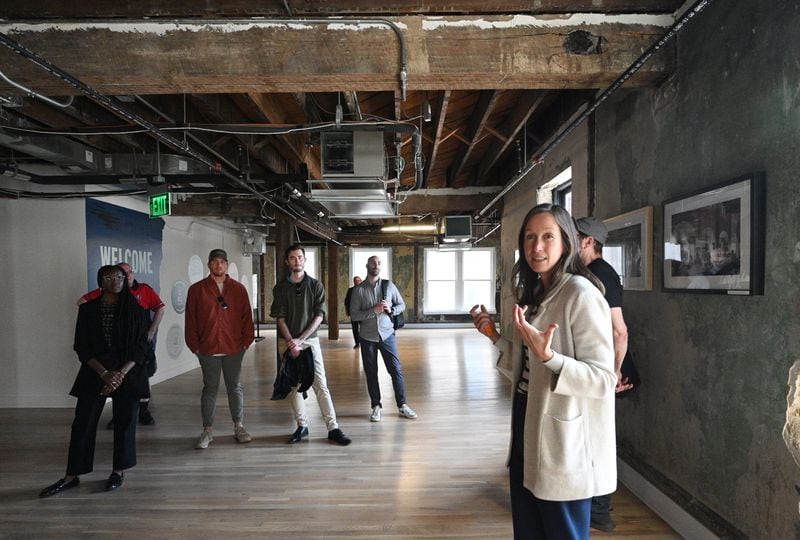 April Stammel speaks to attendees as they tour inside The Sylvan Building on 233 Mitchell St SW during walking tour of South Downtown, Tuesday, March 12, 2024, in Atlanta. (Hyosub Shin / Hyosub.Shin@ajc.com)