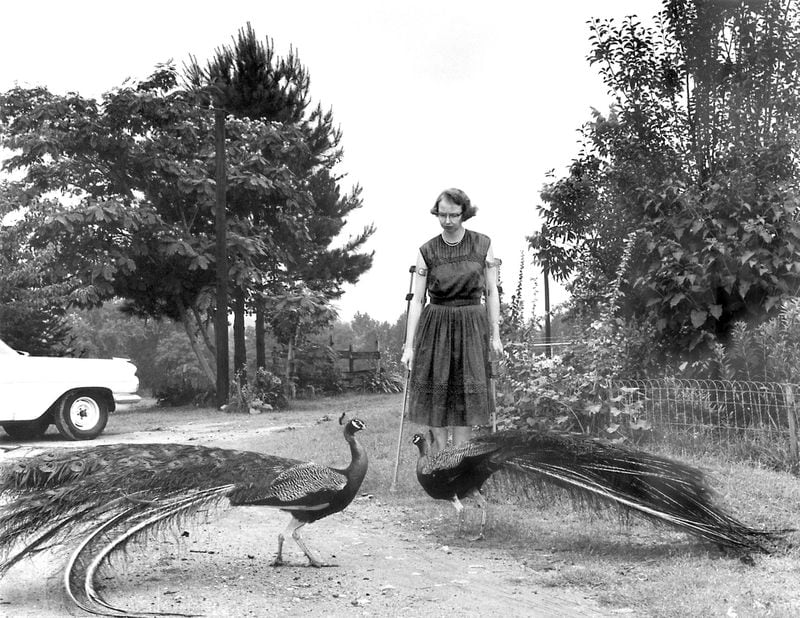 Flannery O’Connor in the driveway at Andalusia, 1962. AJC FILE