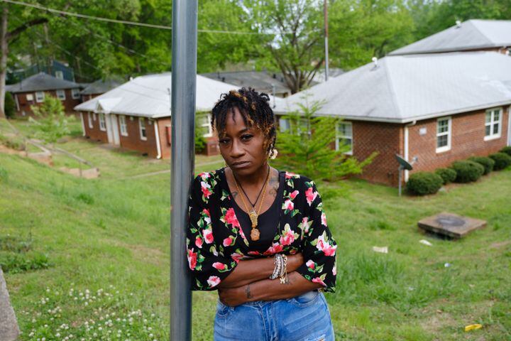 Miracle Fletcher poses for a portrait in front of the Trestletree Village apartments in Atlanta on Wednesday, April 20, 2022. She endured not only the horrific conditions of her apartment but also threats of eviction and retribution for demanding repairs and organizing other tenants to do the same. (Arvin Temkar / arvin.temkar@ajc.com)