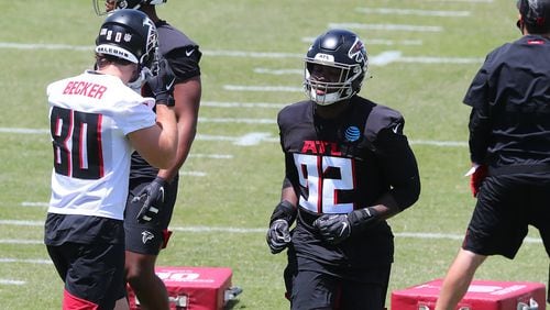 Falcons outside linebacker Ade Ogundeji (center) sprints to the next drill during rookie minicamp Friday, May 14, 2021, in Flowery Branch.  (Curtis Compton / Curtis.Compton@ajc.com)