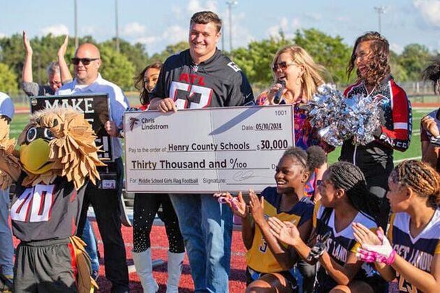 Atlanta Falcons player Chris Lindstrom - along with Falcons cheerleaders, mascot Freddie Falcon, and other Falcons representatives -  presented a $30,000 donation to Henry County Schools to fund middle school girls flag football. (Photo Courtesy of Toni Lee)