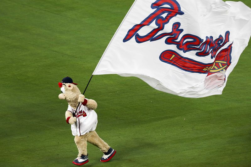 Braves mascot Blooper runs the team flag across the field after the Braves beat the Phillies during a season opener game at SunTrust Park on March 29, 2018. The Braves beat the Phillies, 8-5. (Alyssa Pointer/AJC)
