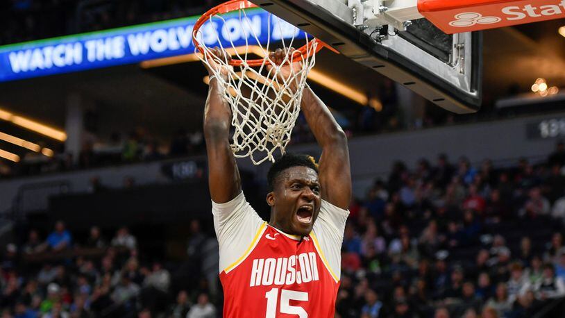 Clint Capela, then with the Rockets, yells after dunking the ball against the Minnesota Timberwolves. (AP Photo/Craig Lassig)