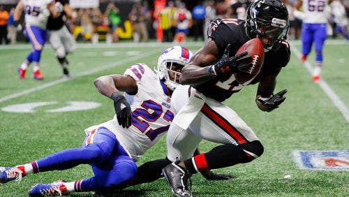 Falcons wide receiver Julio Jones makes a catch over Tre'Davious White of the Buffalo Bills during the first half at Mercedes-Benz Stadium on Oct. 1, 2017, in Atlanta.