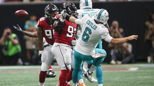 Atlanta Falcons defensive tackle Grady Jarrett (97) hits Miami Dolphins quarterback Jay Cutler (6) drawing a penalty during the second half of an NFL football game, Sunday, Oct. 15, 2017, in Atlanta. Jarrett drew a foul on there play for roughing the passer. (AP Photo/John Bazemore)