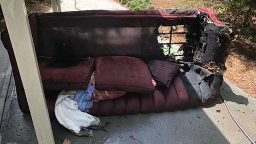 A woman might have been smoking on her couch when a fire overwhelmed her, but a neighbor smashed her sliding glass door wish a rock and dragged her from the flames on Friday, July 20, 2018, said Cobb County fire authorities.