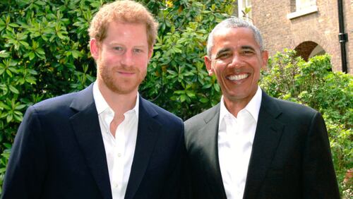 Prince Harry (left) poses with former  President Barack Obama following a meeting at Kensington Palace on Saturday in London.