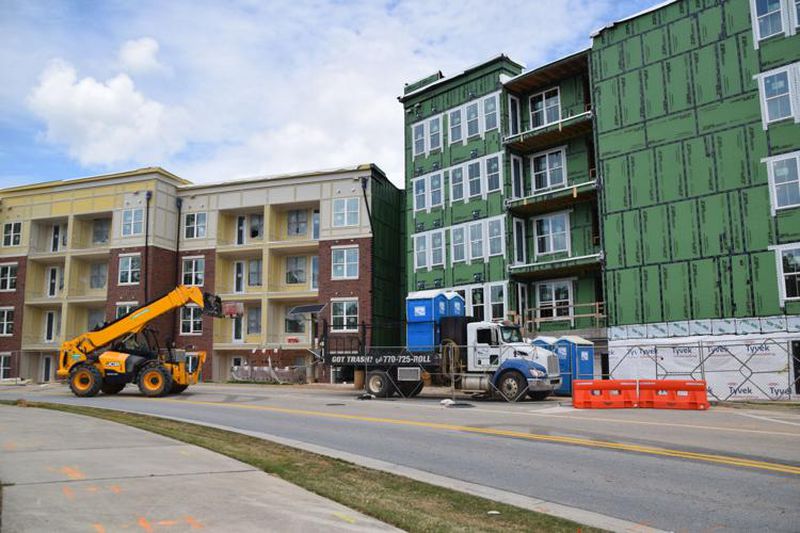 A construction vehicle moves materials around at some of the farthest along parts of luxury apartments which are being built at the site of the mixed-use downtown development. (Courtesy of Curt Yeomans)