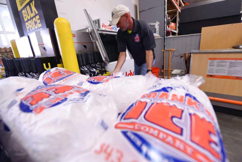 Mike Herring with Frank's Ice Company unloads another pallet of ice as people buy supplies at The Home Depot on Monday, Sept. 10, 2018, in Wilmington, N.C. Hurricane Florence rapidly strengthened into a potentially catastrophic hurricane on Monday as it closed in on North and South Carolina, carrying winds and water that could wreak havoc over a wide stretch of the eastern United States later this week. (Ken Blevins/The Star-News via AP)