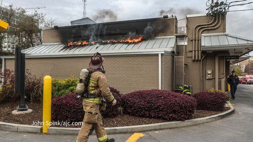 Atlanta firefighters battle blaze at a Midtown McDonald's after its marquee went up in flames Monday morning.