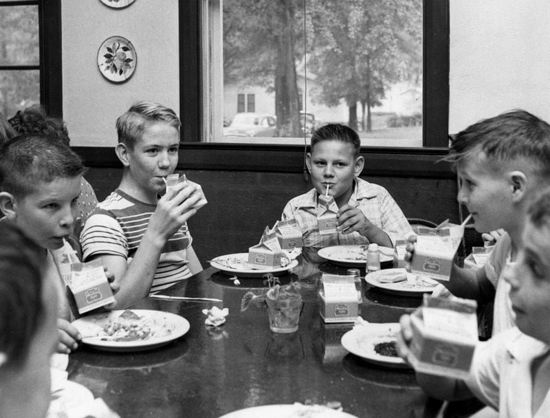 Milk in cartons was a mainstay of school lunches, including at Rome’s East Main School in the 1950s. (Margaret Shannon / AJC file)