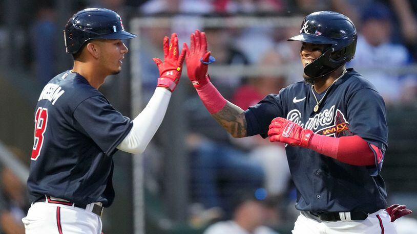 Atlanta Braves Orlando Arcia is greeted by Vaughn Grissom, left, on his two-run homer in the sixth inning of a spring training baseball game against the Philadelphia Phillies in North Port, Fla., Saturday, March 18, 2023. (AP Photo/Gerald Herbert)