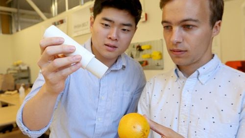 University of Washington engineering students Ha Seung Chung, left, and Shawn Swanson demonstrate their inexpensive replacement for the EpiPen. (Greg Gilbert/Seattle Times/TNS)