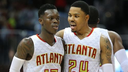 April 24, 2017, Atlanta: Dennis Schroder and Kent Bazemore celebrate a 111-101 victory over the Wizards in game 4 of a first-round NBA basketball playoff series on Monday, April 24, 2017, in Atlanta.  Curtis Compton/ccompton@ajc.com