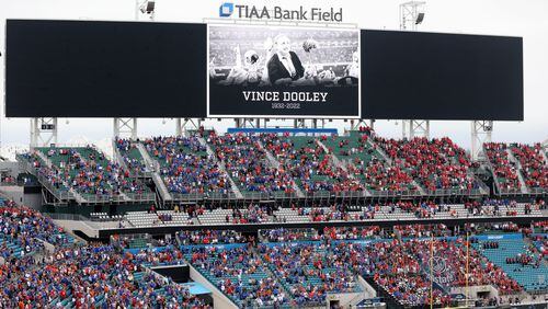 Fans hold a moment of silence for former Bulldogs head football coach and athletic director Vince Dooley before the football game between the Bulldogs and the Gators on Saturday at TIAA Bank Field in Jacksonville, Fla. (Jason Getz / Jason.Getz@ajc.com)