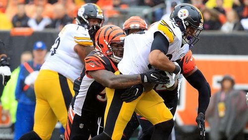 CINCINNATI, OH - OCTOBER 14:  Vontaze Burfict #55 of the Cincinnati Bengals and Shawn Williams #36 combine to tackle James Conner #30 of the Pittsburgh Steelers during the second quarter at Paul Brown Stadium on October 14, 2018 in Cincinnati, Ohio. (Photo by Andy Lyons/Getty Images)