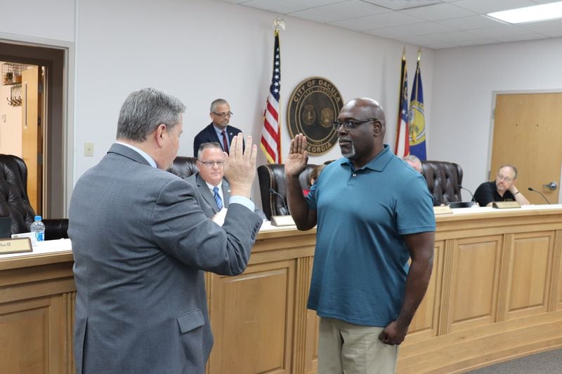 Denis Haynes (right) is sworn into office on May 6. He'll fill the open seat on the Dacula City Council left by longtime Councilmember Wendell Holcombe. (Tyler Wilkins / tyler.wilkins@ajc.com)
