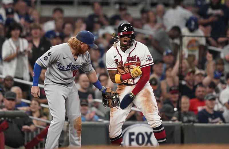 Braves outfielder Ronald Acuna (right) reacts after sliding safely into third against Los Angeles Dodgers third baseman Justin Turner (10) in the seventh inning Saturday, June 5, 2021, in Atlanta. (Brynn Anderson/AP)