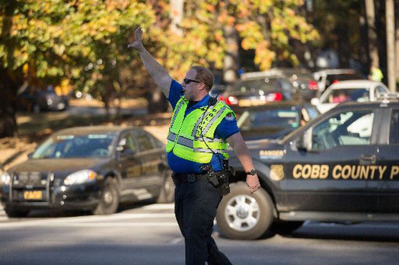 A Cobb County Police officer directs traffic near Ridgeview Institute on South Cobb Drive where a man walked in and opened fire after he fought with staff, Wednesday, Nov. 16, 2016, in Smyrna, Ga. BRANDEN CAMP/SPECIAL