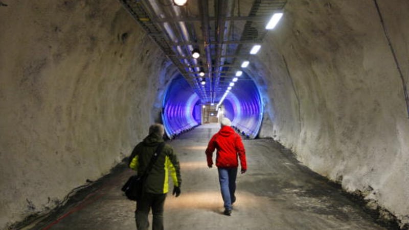People walk into the doomsday seed vault, aimed at providing a type of Noah's Ark of food storage in the event of a global catastrophe, through an entrance tunnel. Permafrost meltwater breached the tunnel leading to the vault after extremely warm winter temperatures. The doomsday vault is  filled with samples of the world's most important seeds.