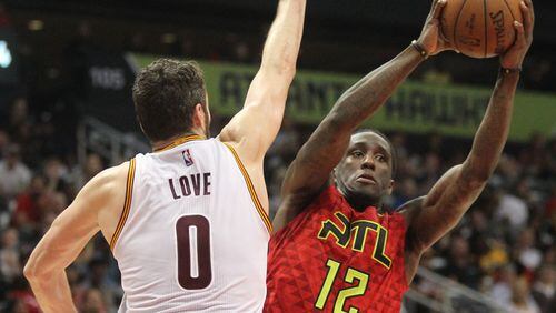 April 9, 2017, Atlanta, Georgia - Atlanta Hawks forward Taurean Prince (12) gets past the arms of Cleveland Cavaliers forward Kevin Love (0) in an NBA game between the Atlanta Hawks and Cleveland Cavaliers at Phillips Arena in Atlanta, Georgia, on April 9, 2017. The Hawks won in overtime 126-125 after coming back from being 26 points down in the fourth quarter. (HENRY TAYLOR / HENRY.TAYLOR@AJC.COM)